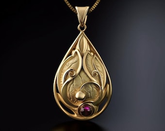 May include: A gold teardrop-shaped pendant suspended from a matching gold chain. The pendant features an intricate, textured leaf-like design with swirling metal accents, a small polished gold sphere, and a single round, deep red gemstone at the base.