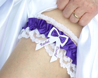 May include: White lace garter with a purple satin bow and a white satin ribbon with the names "Rachel" and "David" embroidered on it.