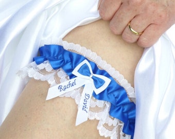 May include: White and blue garter with lace trim and satin ribbon. The ribbon has the names "Rachel" and "David" embroidered on it.