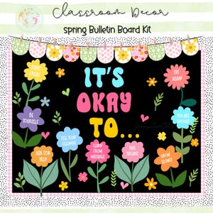 Op de afbeelding: Een zwarte prikbordkit met de tekst "It's Okay To..." en diverse positieve affirmaties. Het ontwerp bevat kleurrijke bloemen, bladeren en een banner met bloemmotieven. De woorden "Start Fresh", "Be Yourself" en "Ask for Help" zijn ook opgenomen.