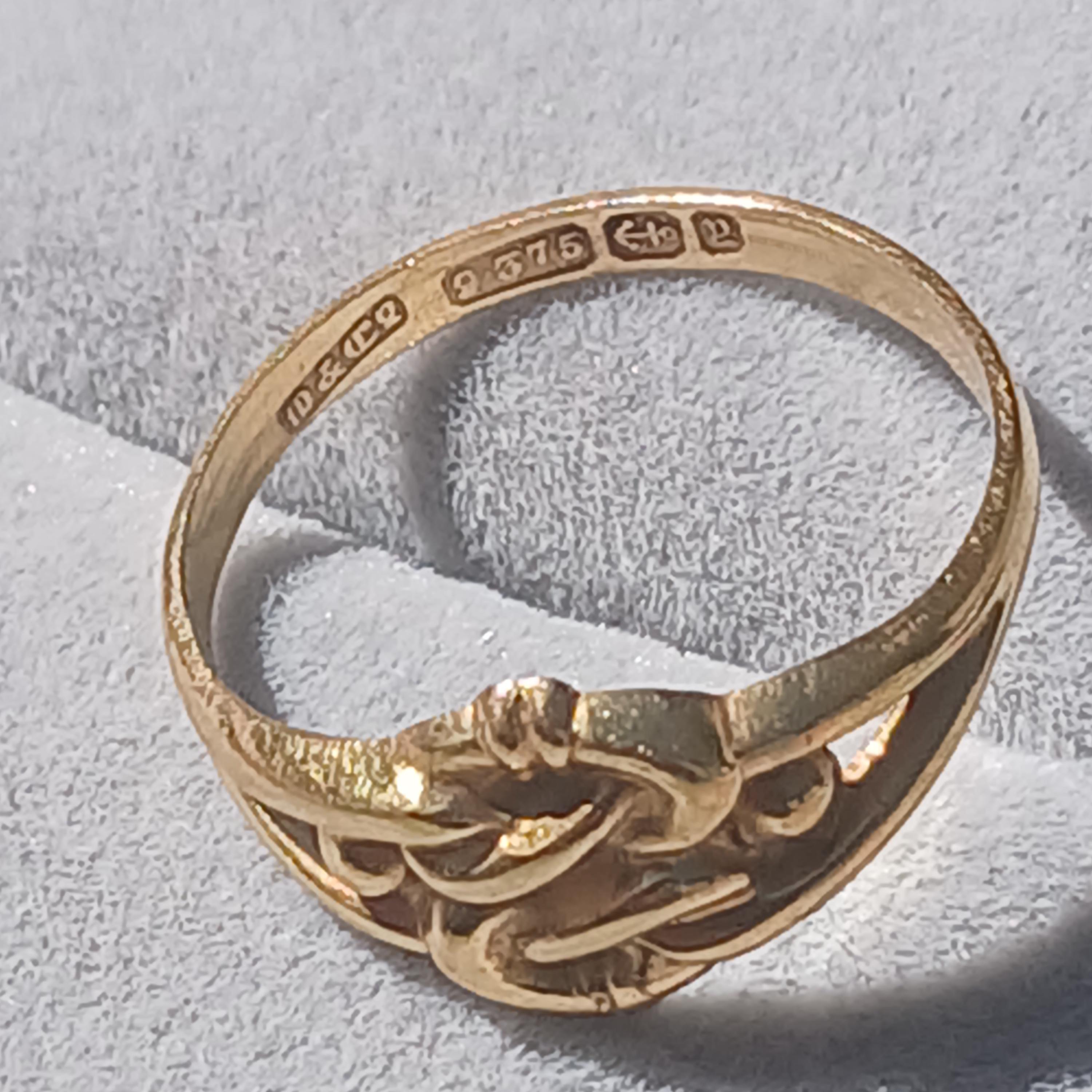May include: A gold ring with a Celtic knot design. The inside of the band is inscribed with "10 & 9 375  <--  12".