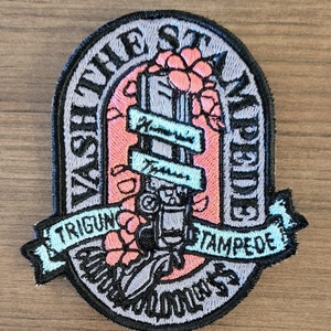 May include: A gray embroidered patch with a gun, flowers, and the text "Wash the Stampede Out" and "Trigun Stampede".