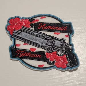 May include: Embroidered patch with a black and silver gun, red flowers, and the text "Humanoid Typhoon" in red.