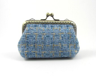 May include: A small blue and gold coin purse with a metal clasp.