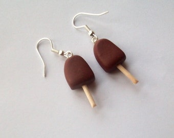 Boucles d’oreilles de crème glacée au chocolat sur un bâton chocolat sucettes