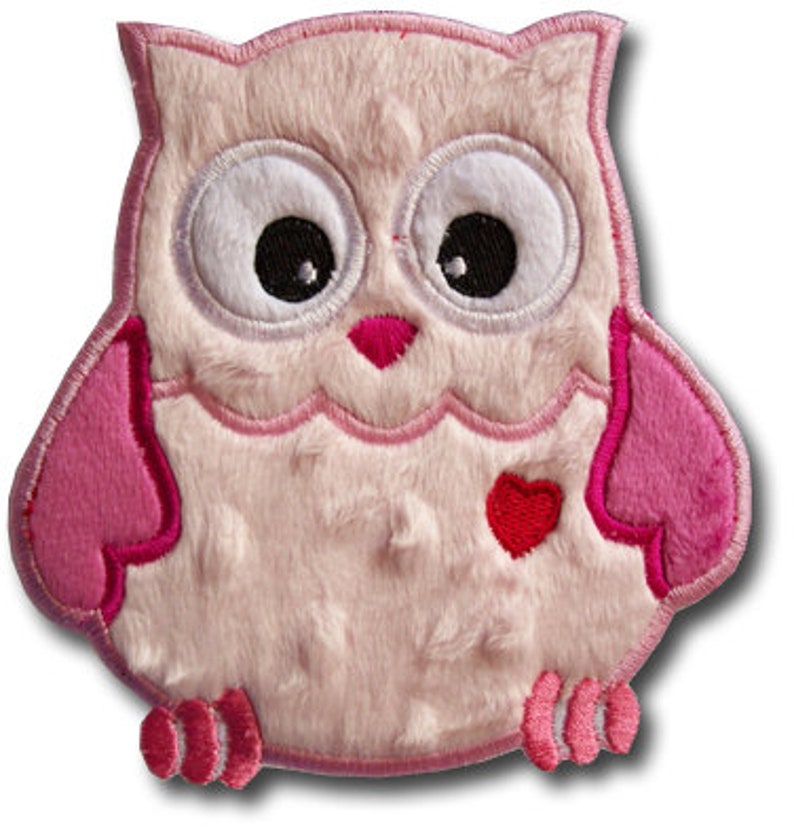 May include: Pink plush owl applique with a red heart on its chest. The owl has embroidered eyes and a pink beak.