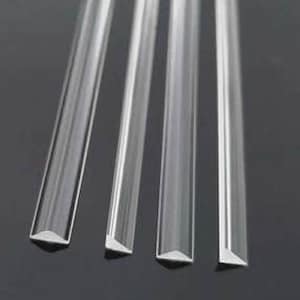 May include: Four clear acrylic rods with beveled edges. The rods are arranged in a row from shortest to longest.