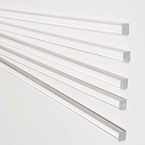May include: Five clear acrylic rods, each with a square cross-section, are arranged in a fan shape. The rods are all the same length and width.
