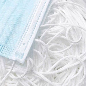 May include: A close-up of a large pile of white elastic cord, commonly used for face masks. The cord is soft and flexible, and it is perfect for crafting and DIY projects.