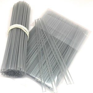 May include: A bundle of clear plastic twist ties in a clear plastic bag. The twist ties are approximately 6 inches long.