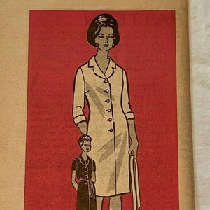 May include: A vintage sewing pattern for a dress. The pattern is printed on paper and features a line drawing of a woman wearing a dress with a collar and buttons. The pattern number is 9095 and the size is 22 1/2. The text "Printed Pattern" is printed at the bottom of the pattern.