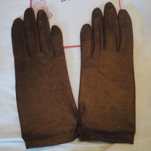 May include: A pair of brown leather gloves. The gloves are long and have a smooth texture.