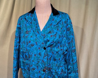 May include: A long blue floral print coat with a black velvet collar and black buttons.