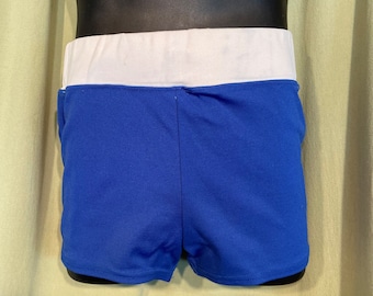 May include: Blue athletic shorts with a white waistband. The shorts are made of a smooth, stretchy fabric.