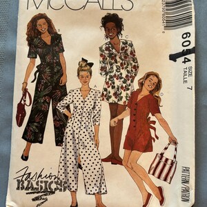 May include: McCall's sewing pattern for a dress, featuring four different styles. The pattern is for size 7 and includes instructions for making a polka dot dress, a floral dress, a red dress, and a jumpsuit. The pattern is labeled "Fashion Basics".