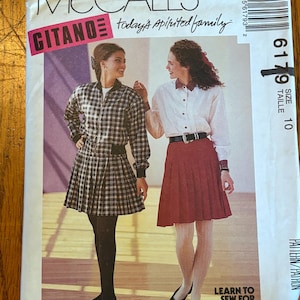 May include: A sewing pattern for a plaid skirt and a white button-down shirt with a collar. The pattern is from McCall's and is called "Citano" and "Today's Spirited Family". The pattern number is 6179 and the size is 10.