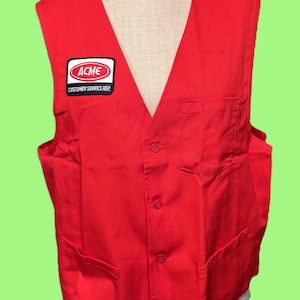 May include: A bright red vest with a V-neck and three buttons. The vest has two front pockets and a patch that reads "ACME CUSTOMER SERVICE REP" in white text on a black background. The vest is displayed on a mannequin.