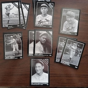 May include: A collection of black and white baseball trading cards featuring images of famous baseball players from the 1920s and 1930s. The cards feature the players' names, nicknames, and years. The cards are in good condition and would be a great addition to any baseball fan's collection.