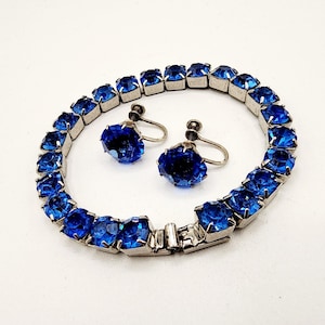 May include: A set of three ceramic mugs with a speckled, matte finish. The mugs are in shades of cream, light gray, and dark gray. Each mug has a simple, minimalist design and a rounded handle.