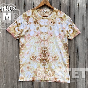 May include: A tie-dye t-shirt in shades of brown, pink, and white with a symmetrical pattern. The shirt is a size M and is unisex.