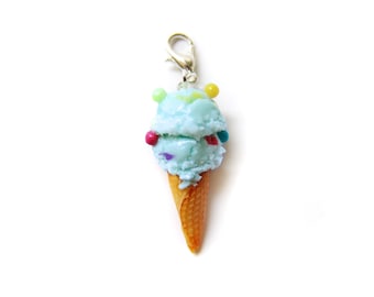 May include: A blue ice cream cone charm with colorful sprinkles and a silver lobster clasp.