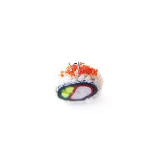 May include: A single piece of sushi with a red and white filling, topped with red tobiko and wrapped in seaweed.