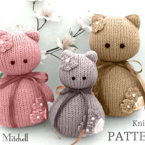 May include: Knitting pattern for three crocheted cat toys. The cats are pink, gray, and brown with white flower accents. The pattern is titled "Knitting PATTERN".