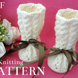 May include: A knitting pattern for white crocheted booties with brown ribbon bows. The pattern is available as a PDF download.  PDF Knitting Pattern.