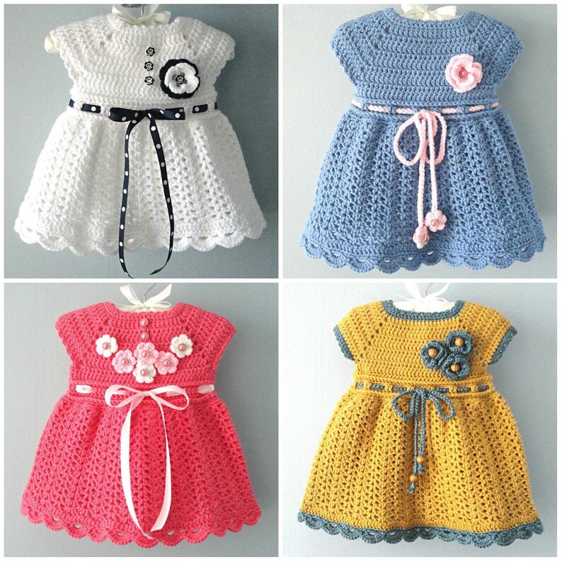 May include: Four crocheted baby dresses in different colours and styles. The dresses have a scalloped hem and are decorated with crocheted flowers.