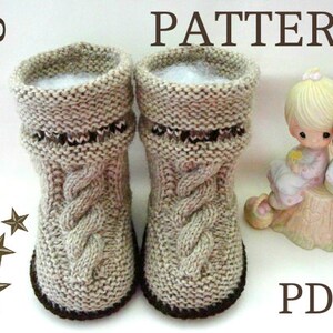 May include: Knitting pattern PDF for a pair of beige knitted baby booties with a cable knit design and brown trim. The pattern is available for download.