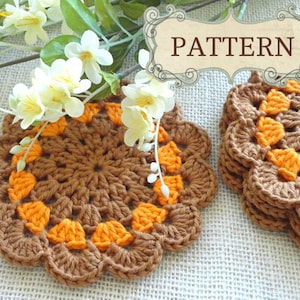 May include: Two crocheted coasters in brown and orange. The coasters are made with a circular pattern and have a scalloped edge.