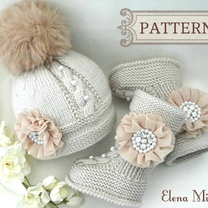 May include: A knitted baby hat and booties set in a light beige color with a fluffy pom pom on the hat. The hat and booties are decorated with beige fabric flowers and rhinestones.