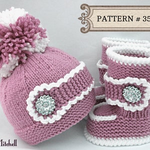 May include: A knitted baby set in a soft pink color, featuring a hat with a large white and pink pom-pom and matching booties. The set is trimmed with white accents and embellished with a decorative jewel. The text "PATTERN # 35" is visible.
