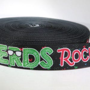 May include: Black ribbon with a green and red print that says "NERDS ROCK!" with a pair of glasses on the word "NERDS".