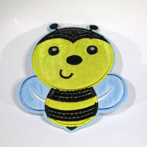 May include: A yellow and black embroidered bee with a smiling face and blue wings. The bee is a cute and cheerful design, perfect for adding a touch of whimsy to any project.