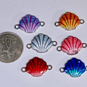 May include: Six colorful seashell charms with silver jump rings. The charms are painted in shades of blue, purple, orange, pink, gray, and red.