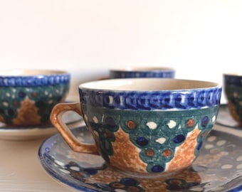 Juego de 4 tazas y platillos de cerámica alemana con efecto salpicado.