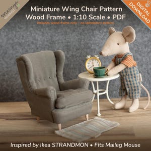 May include: A miniature gray wing chair with a wood frame, part of a pattern for a 1:10 scale model. The image includes a small table, a toy mouse, and a rug. Text on the image says "Miniature Wing Chair Pattern" and "Inspired by Ikea STRANDMON."