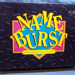 May include: A game box with a colorful design featuring the words "NAME BURST" in large, yellow letters. The box is black with a blue and pink border. The text "The Memory-Jogging, Name-Calling, Who's Who Game!" is printed below the title.
