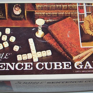 May include: A box for the Scrabble Sentence Cube Game. The box is white with red, brown, and green accents. The game is made by Selchow & Righter Co. and is from 1971. The box shows a couple playing the game on a table with books and a hourglass.