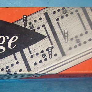 May include: A vintage Cribbage game box with a red and black design. The box features the text "Cardinal's Wood Cribbage with 2-Player Board." The game board is visible on the box, with peg holes and the text "The most exciting 2-Handed Card Game in America!"