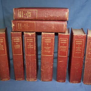 May include: A set of ten red hardcover books with gold lettering. The books are part of the Harvard Classics series and include titles such as "Modern English Drama", "Selected English Writings", "The Imitation of Christ", and "Poems and Songs of Burns".
