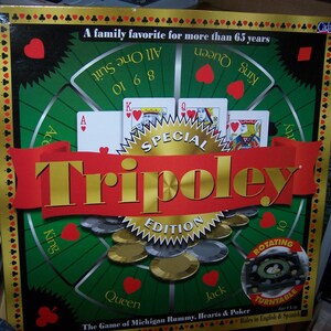 May include: Tripoley Special Edition board game. The box features a green and gold design with playing cards, poker chips, and the game's name in large gold letters. Includes a rotating turntable. Ages 8 & up.