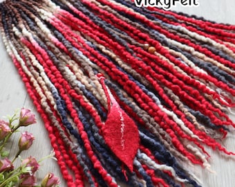 May include: Handmade dreadlocks in shades of red, brown, blue, and cream. The dreads are arranged in a bundle, with a red felt leaf accent. The text "VickyFelt" is visible in the upper right corner.