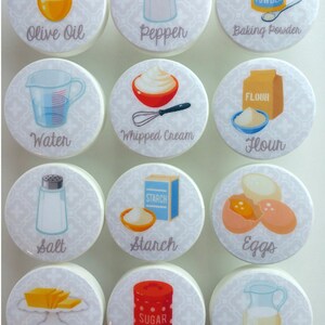 May include: Set of 12 white round kitchen cabinet knobs with colorful illustrations of baking ingredients, including olive oil, pepper, baking powder, water, whipped cream, flour, salt, starch, eggs, butter, sugar, and milk.