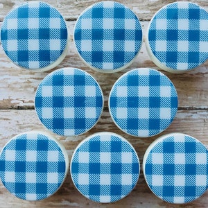 May include: Eight round white ceramic knobs with a blue and white gingham pattern.