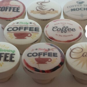 May include: Set of ten ceramic coffee themed bottle stoppers. Each stopper features a different coffee design with text such as "Good Morning Coffee", "Tasty Coffee", and "Coffee Lover".