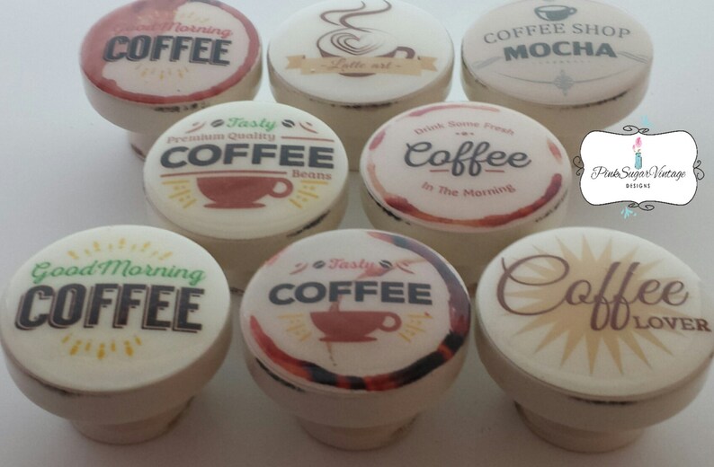 May include: Set of ten ceramic coffee themed bottle stoppers. Each stopper features a different coffee design with text such as "Good Morning Coffee", "Tasty Coffee", and "Coffee Lover".