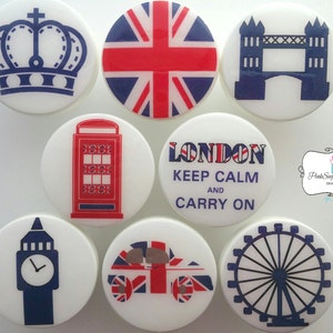 May include: Eight round white ceramic coasters with various London themed designs. The designs include a crown, the Union Jack flag, Tower Bridge, a red telephone booth, a London bus, the London Eye, Big Ben, and a text design that says "London Keep Calm and Carry On".