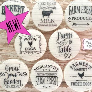 May include: Set of ten round, white, wooden signs with black text and graphics. The signs feature various farm-themed phrases, such as "Farm Fresh Produce", "Farm to Table", and "Grow Your Garden".